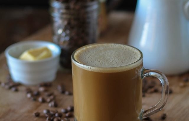 Bulletproof Coffee - brewed coffee + grassfed butter + coconut oil blended together in a blender makes a frothy latte! | TheRoastedRoot.net #paleo #recipe #healthy #drink