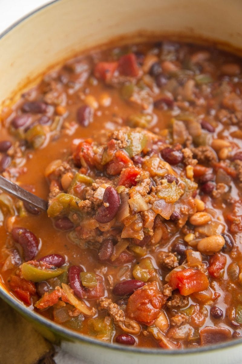 Big pot of turkey chili with a ladle, about to serve.