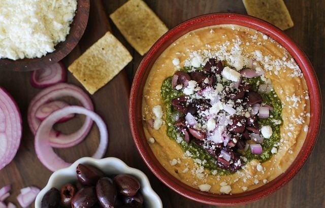 Mediterranean Hummus with Pesto and Feta | TheRoastedRoot.net #appetizer #healthy #recipe