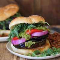 The Ultimate Grilled Portobello Burger with grilled eggplant, roasted red peppers, red onion, arugula, and pesto sauce | TheRoastedRoot.net #healthy #vegetarian #recipe