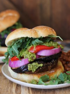 The Ultimate Grilled Portobello Burger with grilled eggplant, roasted red peppers, red onion, arugula, and pesto sauce | TheRoastedRoot.net #healthy #vegetarian #recipe