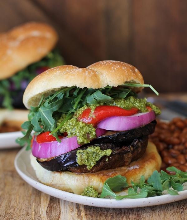 The Ultimate Grilled Portobello Burger with grilled eggplant, roasted red peppers, red onion, arugula, and pesto sauce | TheRoastedRoot.net #healthy #vegetarian #recipe