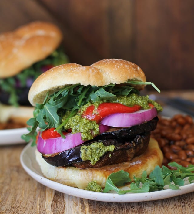 The Ultimate Grilled Portobello Burger with grilled eggplant, roasted red peppers, red onion, arugula, and pesto sauce | TheRoastedRoot.net #healthy #vegetarian #recipe