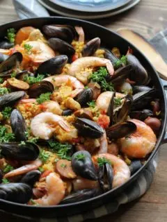 Seafood Paella with chicken, sausage, shrimp, and mussels - a delicious tapas recipe to serve to guests | TheRoastedRoot.net #healthy #dinner #recipe #spanish #glutenfree