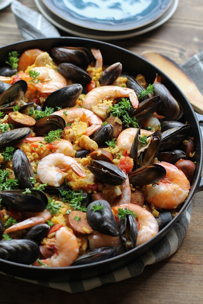 Seafood Paella with chicken, sausage, shrimp, and mussels - a delicious tapas recipe to serve to guests | TheRoastedRoot.net #healthy #dinner #recipe #spanish #glutenfree