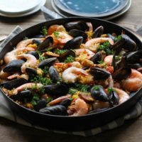 Seafood Paella with chicken, sausage, shrimp, and mussels - a delicious tapas recipe to serve to guests | TheRoastedRoot.net #healthy #dinner #recipe #spanish #glutenfree