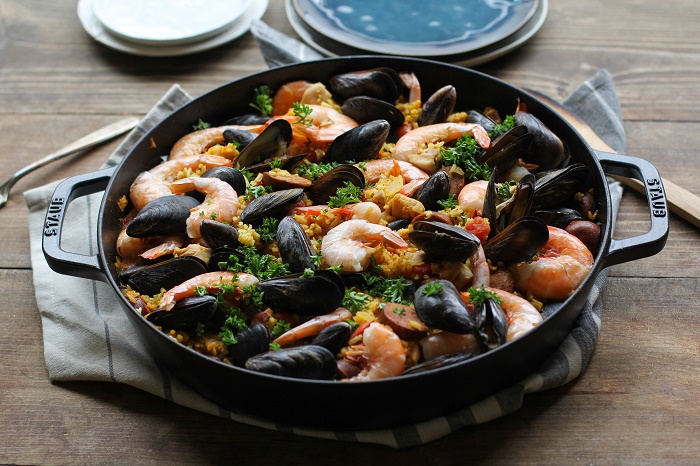 Seafood Paella with chicken, sausage, shrimp, and mussels - a delicious tapas recipe to serve to guests | TheRoastedRoot.net #healthy #dinner #recipe #spanish #glutenfree