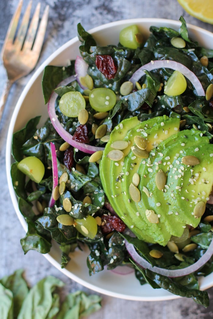 Lemon Basil Kale Salad with grapes, pumpkin seeds, and avocado | TheRoastedRoot.net #healthy #salad #recipe #detox #vegan #vegetarian