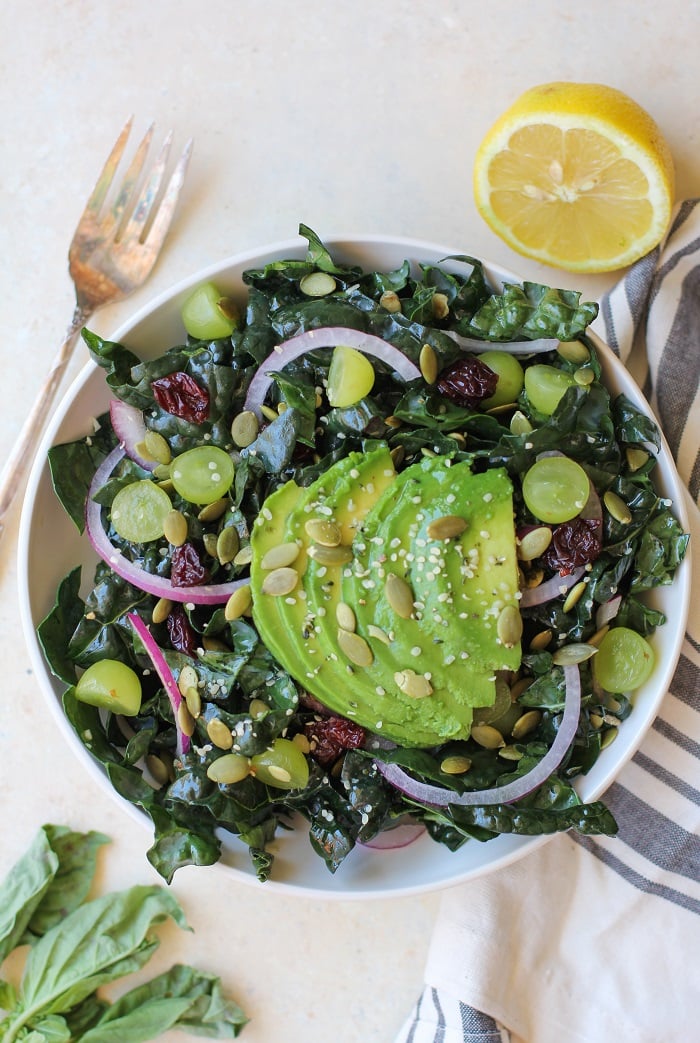 Lemon Basil Kale Salad with grapes, pumpkin seeds, and avocado | TheRoastedRoot.net #healthy #salad #recipe #detox #vegan #vegetarian