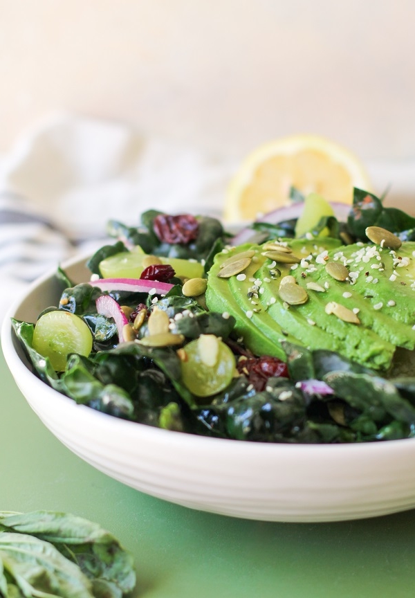 Lemon Basil Kale Salad with grapes, pumpkin seeds, and avocado | TheRoastedRoot.net #healthy #salad #recipe #detox #vegan #vegetarian