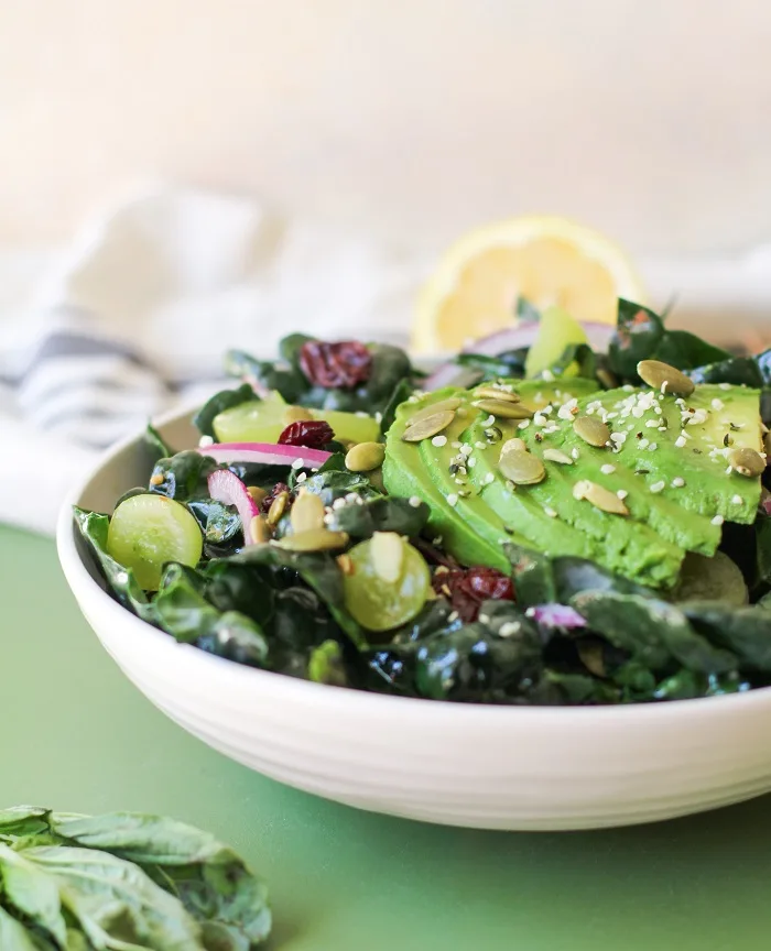 Lemon Basil Kale Salad with grapes, pumpkin seeds, and avocado | TheRoastedRoot.net #healthy #salad #recipe #detox #vegan #vegetarian