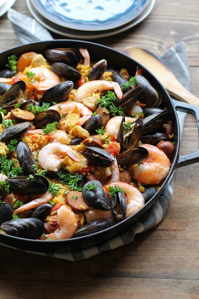 Seafood Paella with chicken, sausage, shrimp, and mussels - a delicious tapas recipe to serve to guests | TheRoastedRoot.net #healthy #dinner #recipe #spanish #glutenfree