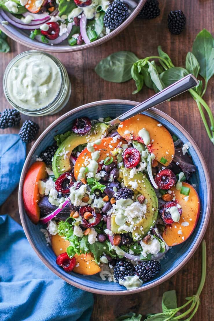 Summer Buddha Bowls with stone fruit, black beans, rice, greens, pistachios, and tahini green goddess dressing #vegetarian #healthy #paleo