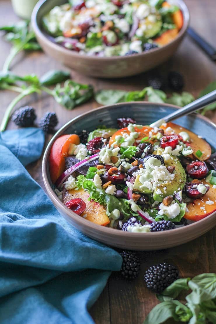 Summer Buddha Bowls with stone fruit, black beans, rice, greens, pistachios, and tahini green goddess dressing #vegetarian #healthy #paleo