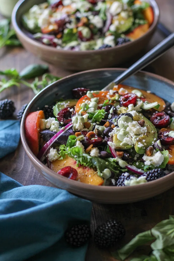 Summer Buddha Bowls with brown rice, mixed greens, summer fruit, black beans, queso fresco, and green goddess dressing | TheRoastedRoot.net #healthy #dinner #recipe #vegetarian 