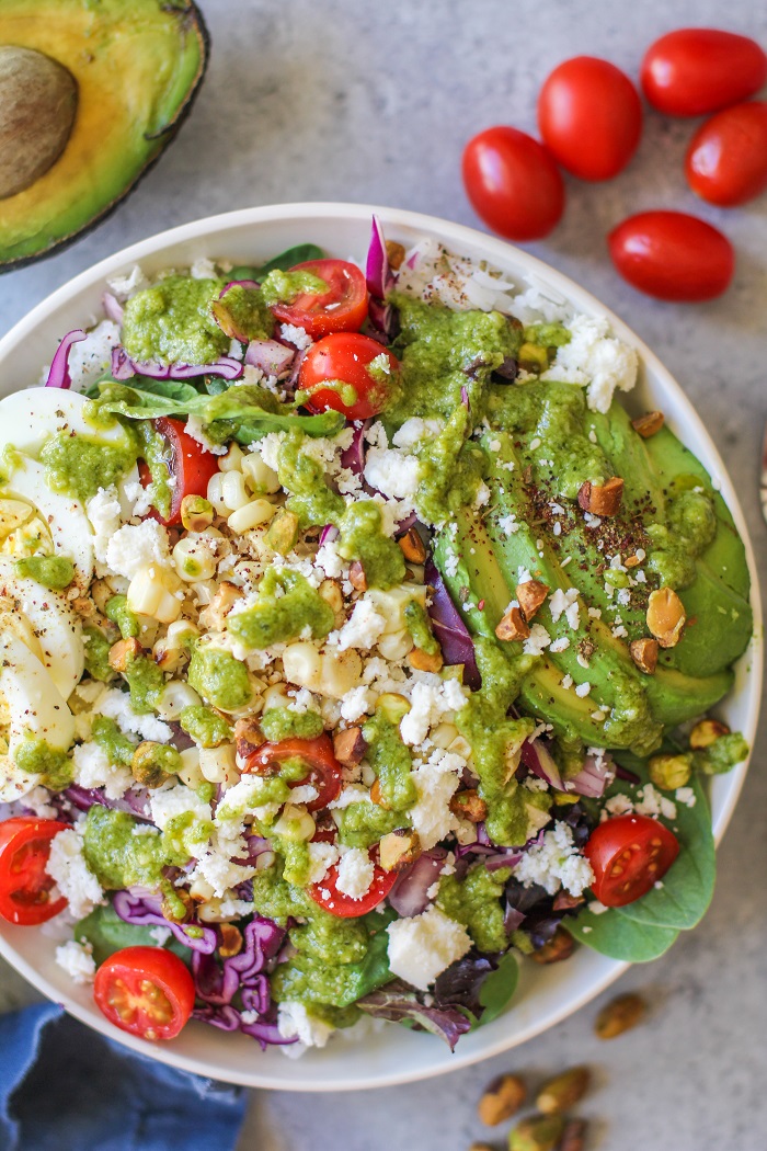 Mexican Street Corn Buddha Bowls with fresh veggies, hard boiled egg, queso fresco, and basil-lime vinaigrette | TheRoastedRoot.net #vegetarian #dinner #recipe #healthy