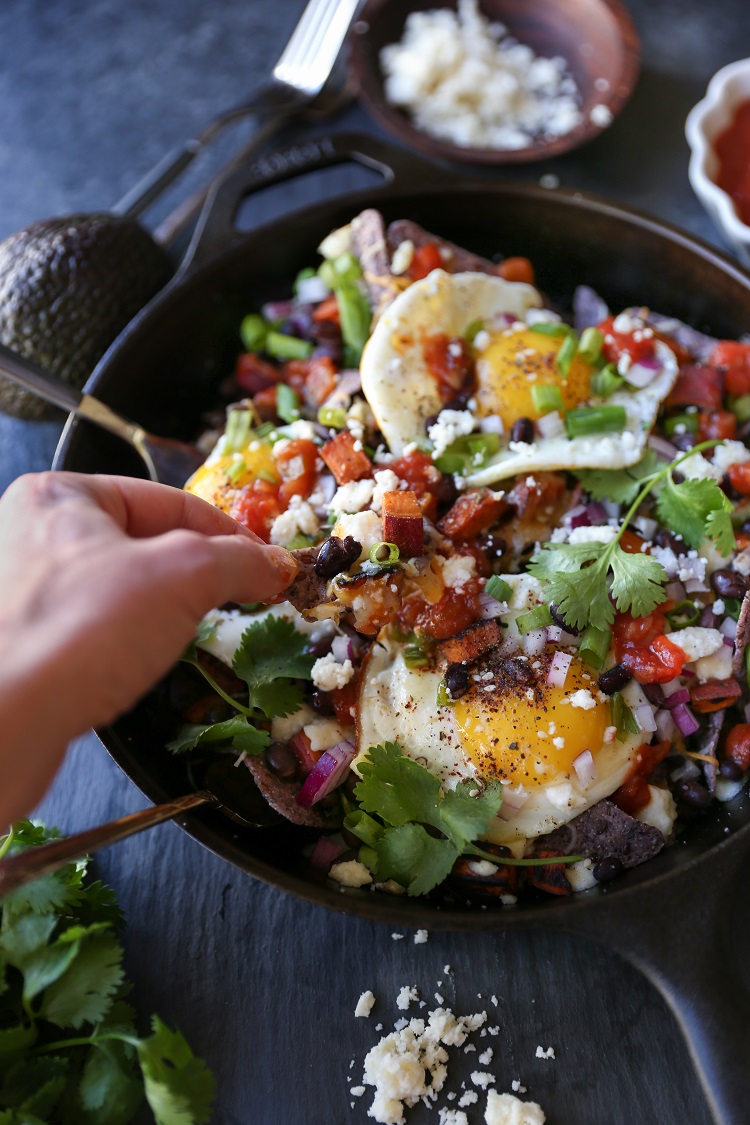 Sweet Potato Huevos Rancheros Nachos with black beans, avocado, sunny side up eggs, salsa, and more | TheRoastedRoot.net #dinner #breakfast #brunch #footballfood #glutenfree #appetizer