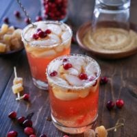 Cranberry Dark and Stormy cocktails on a wooden table, ready to drink.