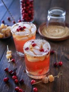 Cranberry Dark and Stormy cocktails on a wooden table, ready to drink.