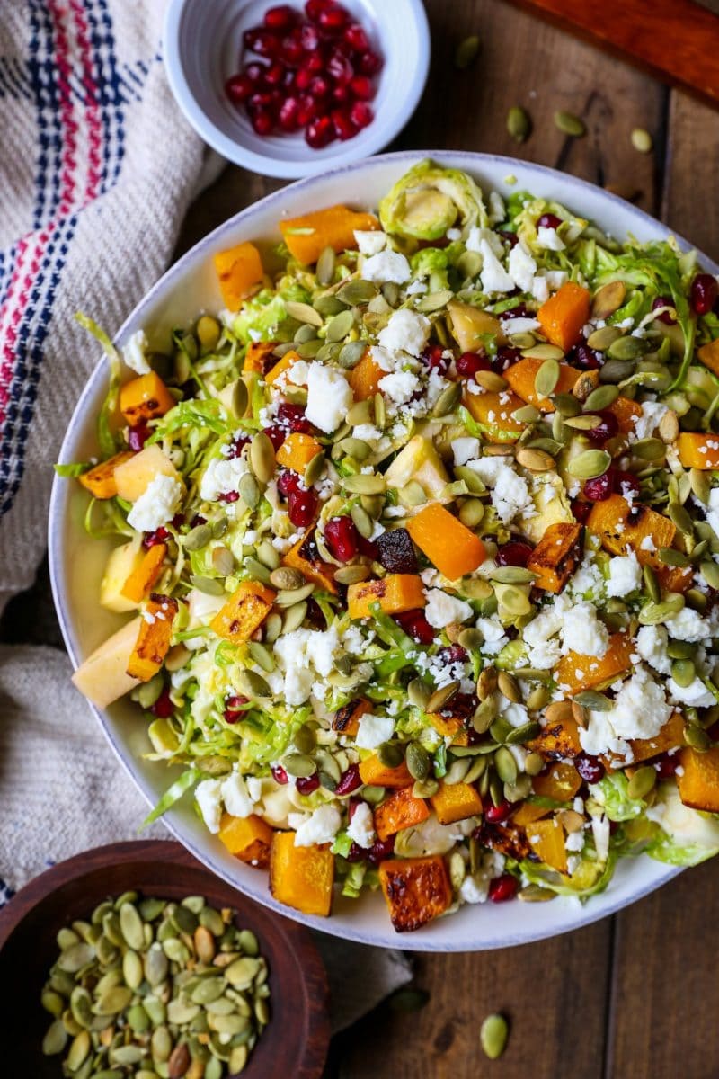 Shaved Brussel Sprout Salad with Roasted Butternut Squash, Pomegranate Seeds, Pumpkin Seeds, Feta, and Citrusy Maple Cinnamon Dressing