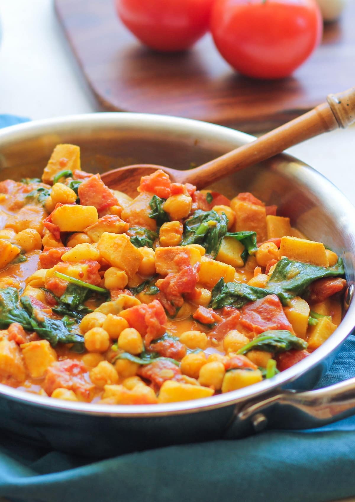 Stainless steel skillet with chana saag inside, ready to serve.