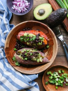 Guacamole and Black Bean Loaded Sweet Potatoes | TheRoastedRoot.net #healthy #glutenfree #recipe #vegan #vegetarian