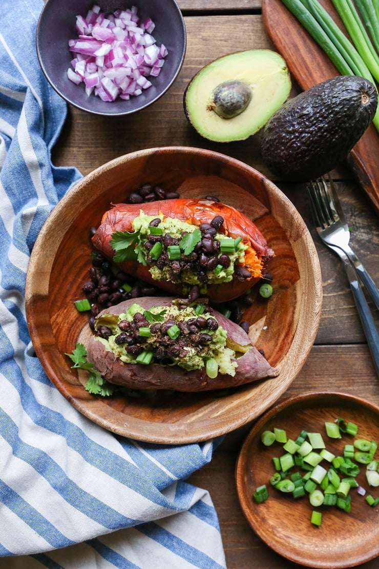 Guacamole and Black Bean Loaded Sweet Potatoes | TheRoastedRoot.net #healthy #glutenfree #recipe #vegan #vegetarian