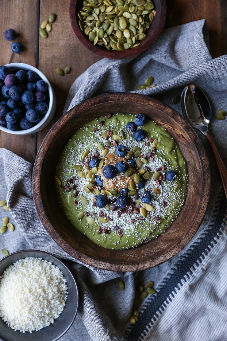 Superfood Green Smoothie Bowl with avocado, greens, cacao nibs, and blueberries | TheRoastedRoot.net #healthy #breakfast #snack