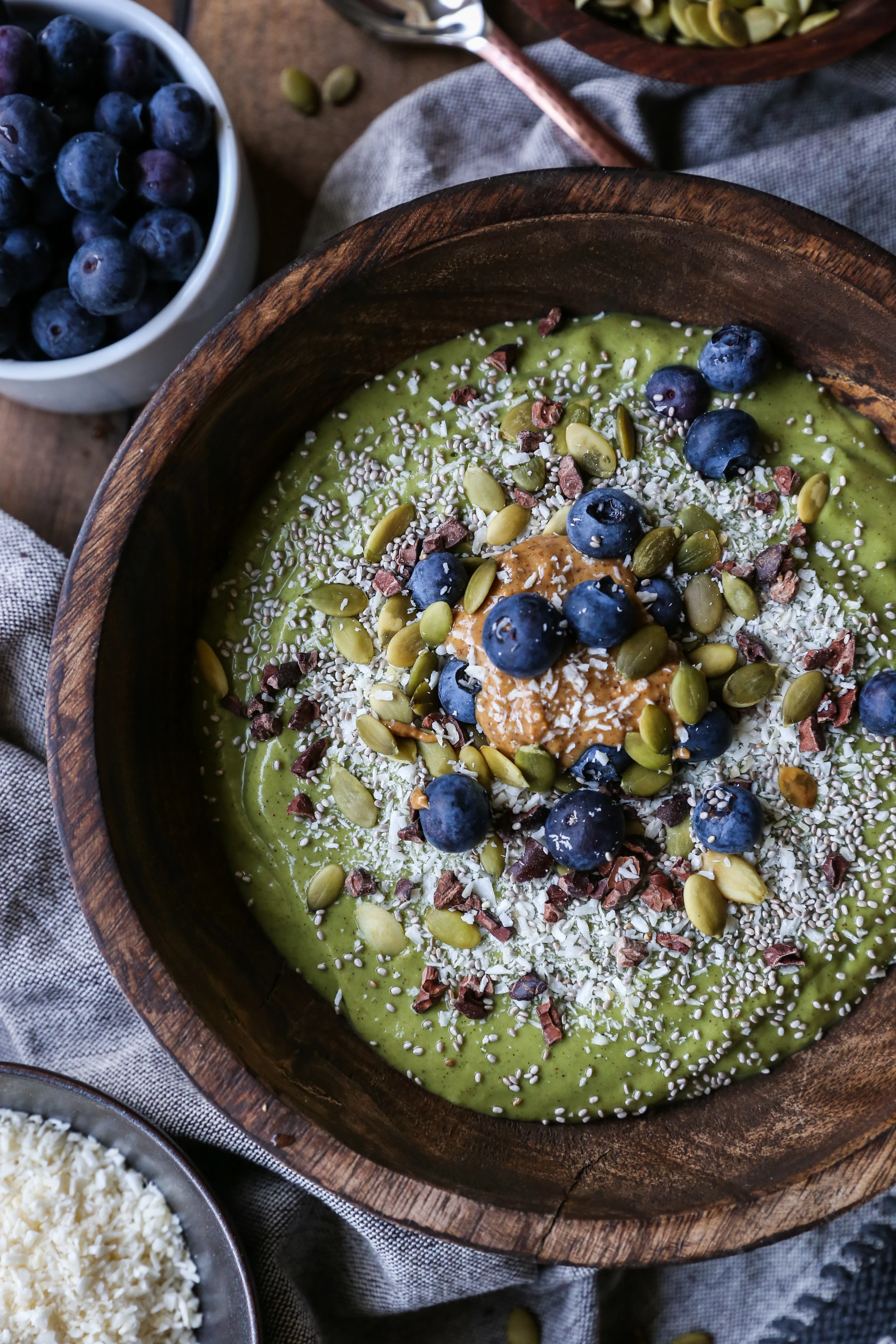 Superfood Green Smoothie Bowl with avocado, greens, cacao nibs, and blueberries | TheRoastedRoot.net #healthy #breakfast #snack