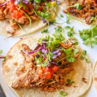 White platter of barbacoa beef tacos