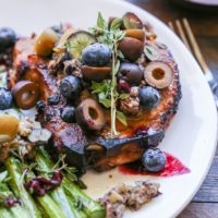 Skillet Pork Chops with Blueberry Olive Tapenade - an easy paleo dinner recipe that only requires 30 minutes and a few ingredients to prepare.