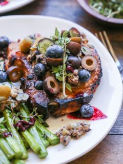 Skillet Pork Chops with Blueberry Olive Tapenade - an easy paleo dinner recipe that only requires 30 minutes and a few ingredients to prepare.