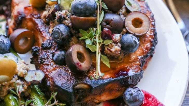 Skillet Pork Chops with Blueberry Olive Tapenade - an easy paleo dinner recipe that only requires 30 minutes and a few ingredients to prepare.