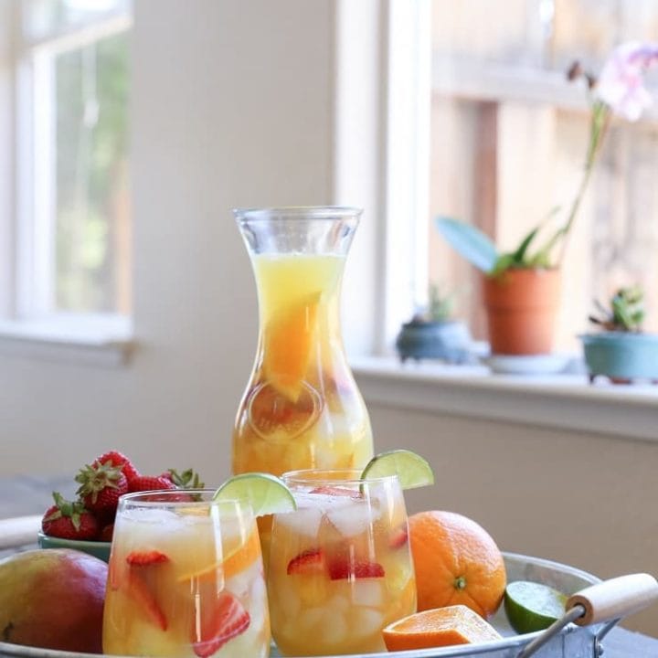 Tropical White Sangria - a naturally sweetened, cocktail recipe. So crisp, refreshing, and perfect for summer gatherings!