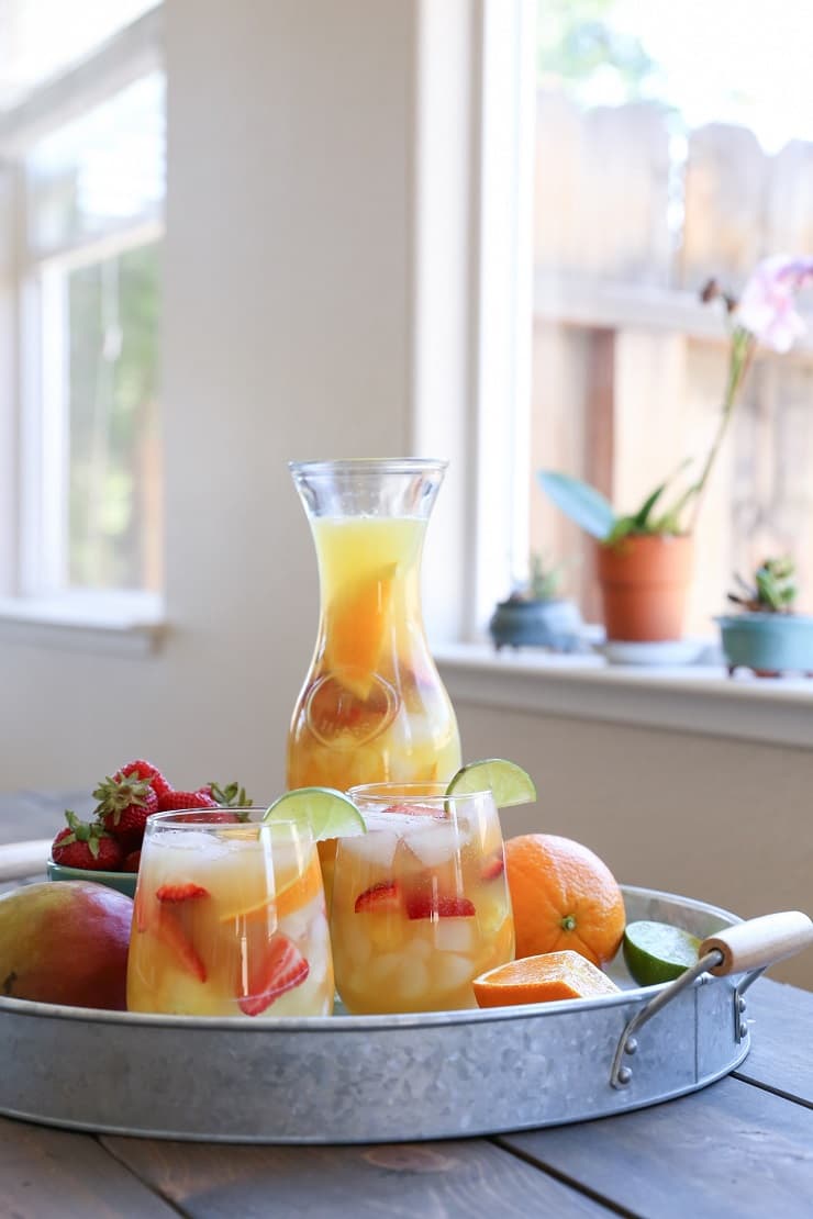 Tropical White Sangria - a naturally sweetened, cocktail recipe. So crisp, refreshing, and perfect for summer gatherings!