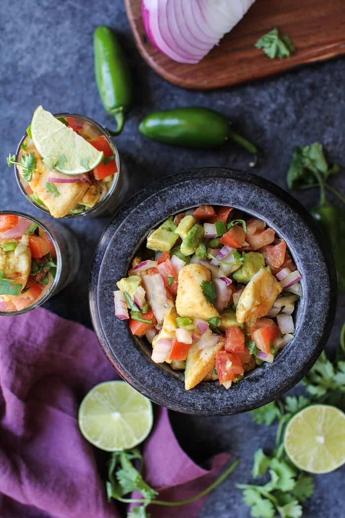 Classic Halibut Ceviche - raw halibut "cooked" in lime juice and mixed with tomatoes, red onion, jalapeno, and avocado. A healthy appetizer that's gluten-free and paleo friendly.