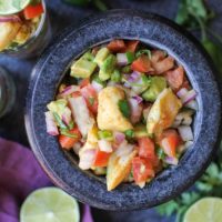 Classic Halibut Ceviche - raw halibut "cooked" in lime juice and mixed with tomatoes, red onion, jalapeno, and avocado. A healthy appetizer that's gluten-free and paleo friendly!