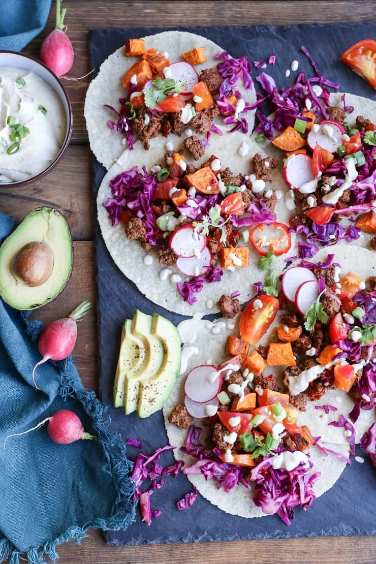 GROUND BEEF TACOS WITH ROASTED SWEET POTATOES AND VEGAN “QUESO” Ground Beef and Roasted Sweet Potato Tacos with Vegan "Queso" a beautifully seasoned and delightfully simple meal! #dinner #paleo #healthy