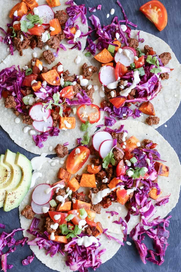 GROUND BEEF TACOS WITH ROASTED SWEET POTATOES AND VEGAN “QUESO” Ground Beef and Roasted Sweet Potato Tacos with Vegan "Queso" a beautifully seasoned and delightfully simple meal! #dinner #paleo #healthy