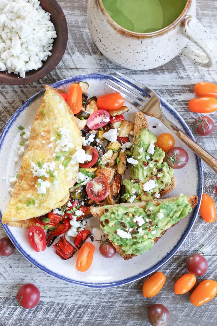 Late Summer Balsamic Roasted Vegetable Omelettes - this veggie-packed omelette includes zucchini, yellow squash, bell pepper, tomatoes, chives, and feta cheese for a winning breakfast.
