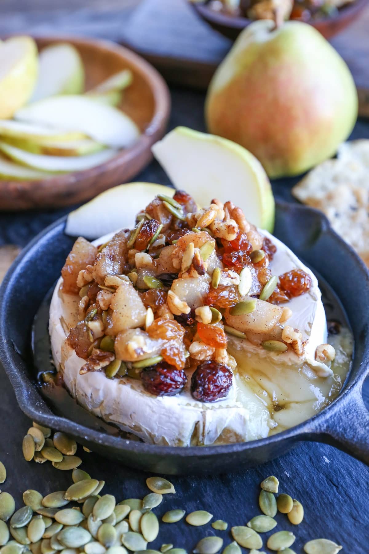 Maple-Spiced Pear Baked Brie with Walnuts, Pumpkin Seeds, and Golden Raisins