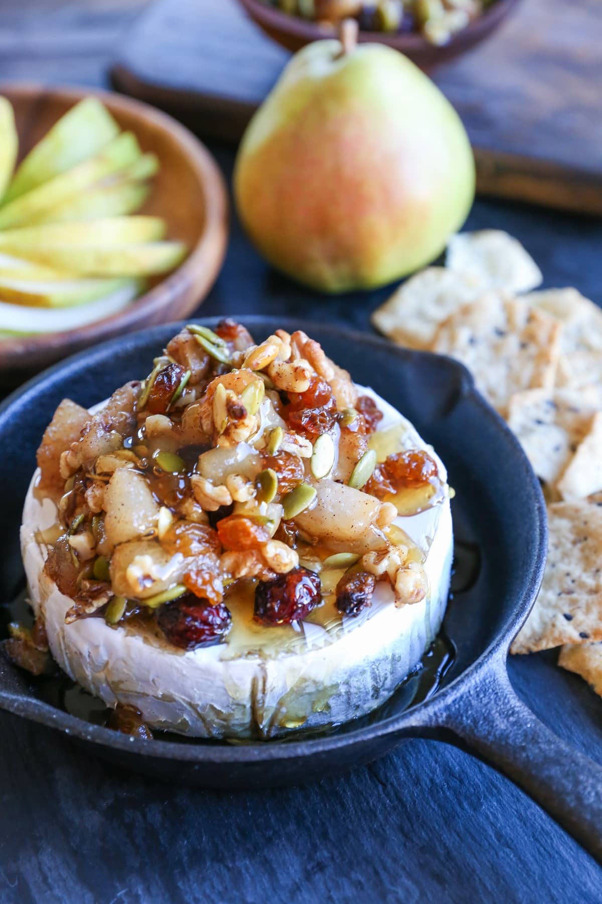 Maple-Spiced Pear Baked Brie with Walnuts, Pumpkin Seeds, and Golden Raisins