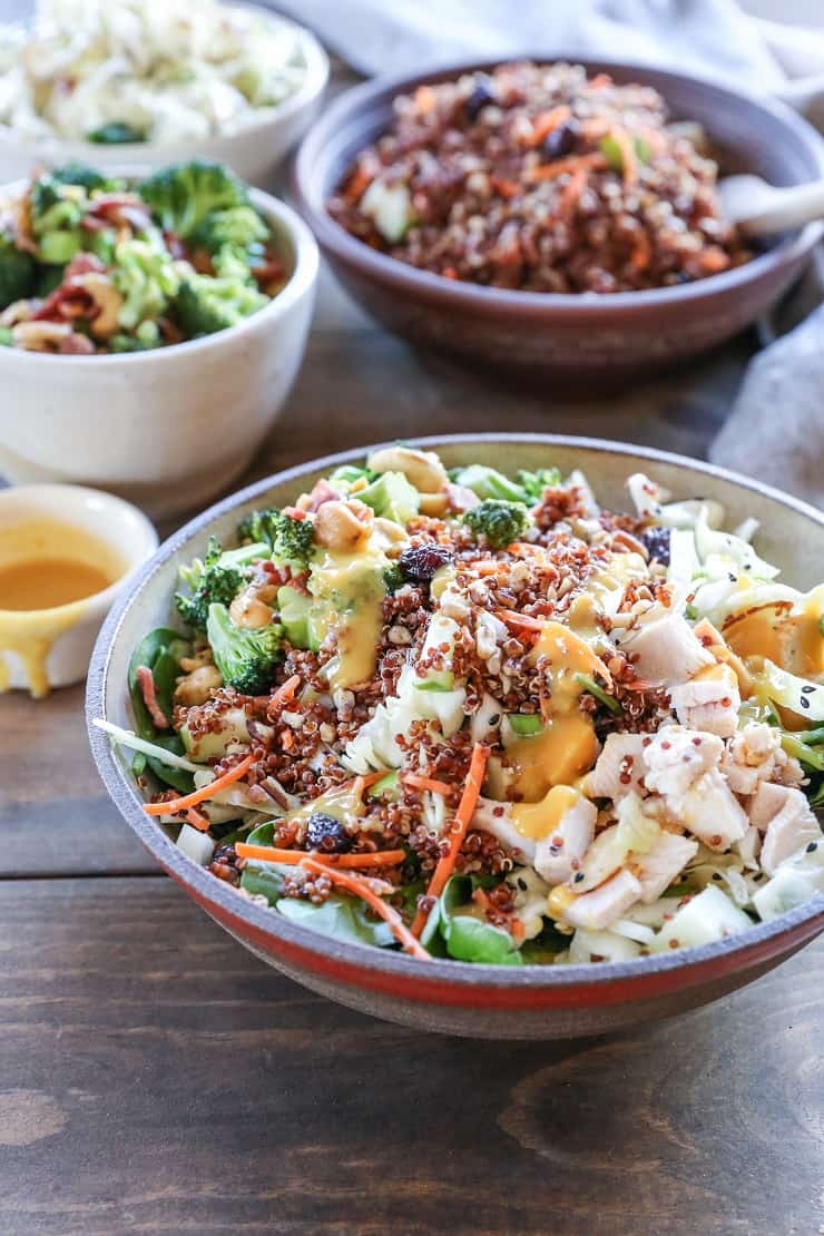 Detox spinach salad with quinoa, broccoli, cabbage, cashews, bacon, dried cranberries, and orange-ginger dressing #paleo #healthy #saladrecipe