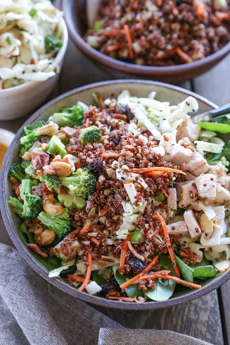 Detox spinach salad with quinoa, broccoli, cabbage, cashews, bacon, dried cranberries, and orange-ginger dressing #paleo #healthy #saladrecipe