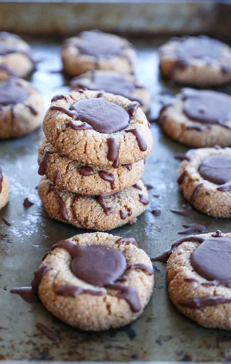 Paleo Chocolate Thumbprint Cookies - grain-free, dairy-free, naturally sweetened, made with almond flour, coconut oil, and pure maple syrup. This healthy gluten free cookie recipe is perfect for the holidays.