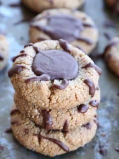 Paleo Chocolate Thumbprint Cookies - grain-free, dairy-free, naturally sweetened, made with almond flour, coconut oil, and pure maple syrup. This healthy gluten free cookie recipe is perfect for the holidays.