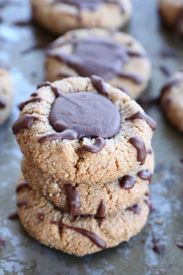 Paleo Chocolate Thumbprint Cookies - grain-free, dairy-free, naturally sweetened, made with almond flour, coconut oil, and pure maple syrup. This healthy gluten free cookie recipe is perfect for the holidays.