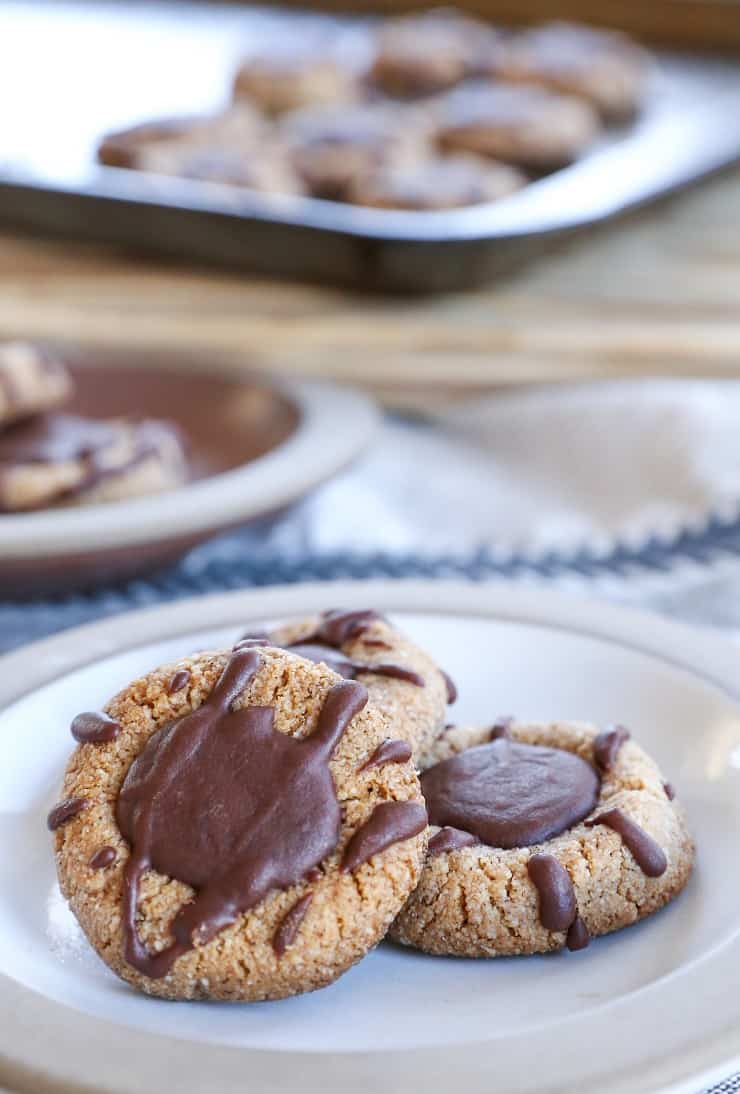 Paleo Chocolate Thumbprint Cookies - grain-free, dairy-free, naturally sweetened, made with almond flour, coconut oil, and pure maple syrup. This healthy gluten free cookie recipe is perfect for the holidays.