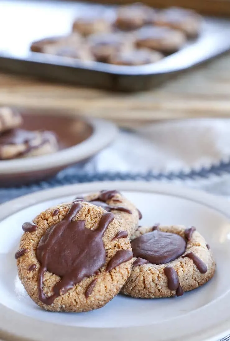 Paleo Chocolate Thumbprint Cookies - grain-free, dairy-free, naturally sweetened, made with almond flour, coconut oil, and pure maple syrup. This healthy gluten free cookie recipe is perfect for the holidays.