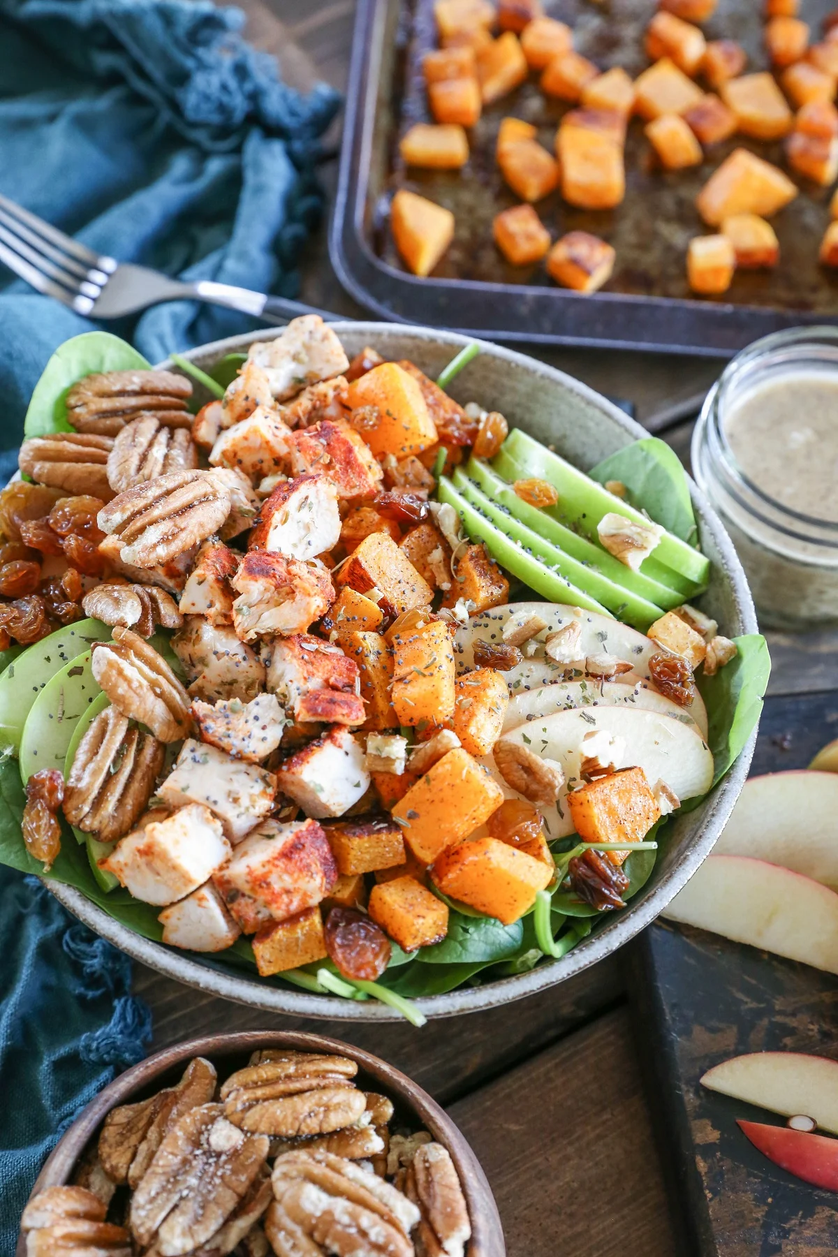 Roasted Butternut Squash Spinach Salad with apples, pecans,golden raisins, and cinnamon maple cider vinaigrette. A healthy whole30 paleo meal!
